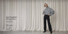 A woman in black All Day Active Midrise Pants styled with an oversized grey checked zip-up jacket, sunglasses and black loafers, against a soft neutral curtain backdrop. Text: Your Wardrobe's Missing Piece. All Day Active Midrise Pants. Take $30 Off* T&Cs apply - Shop Now