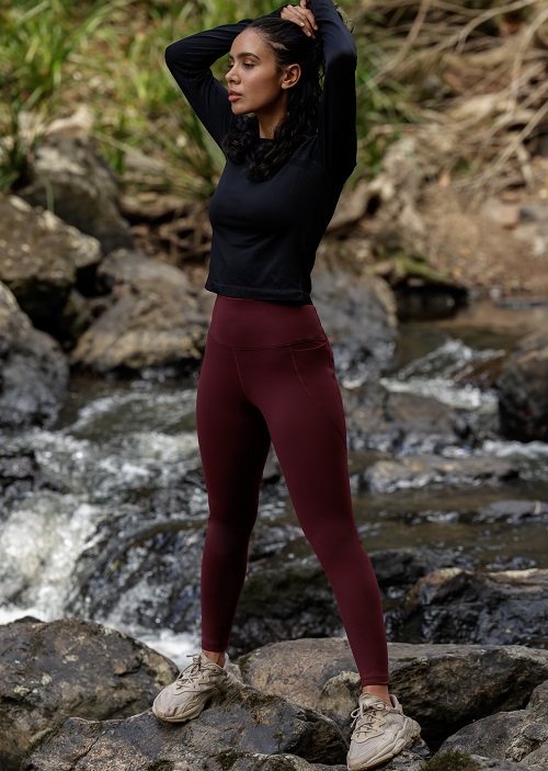 woman wearing maroon thermal full length tights and black long sleeve top