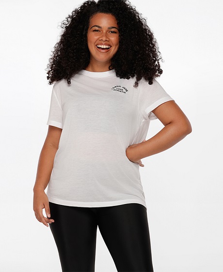 size 14 brunette woman wearing white loose fit tee and black ankle biter leggings