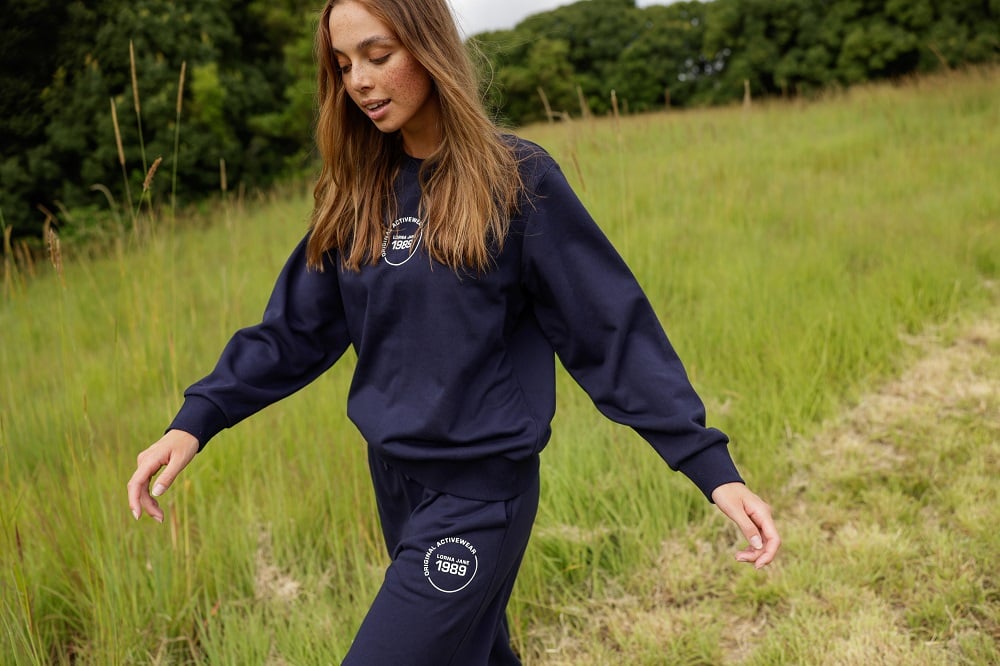 woman wearing matching navy blue trackies and sweater