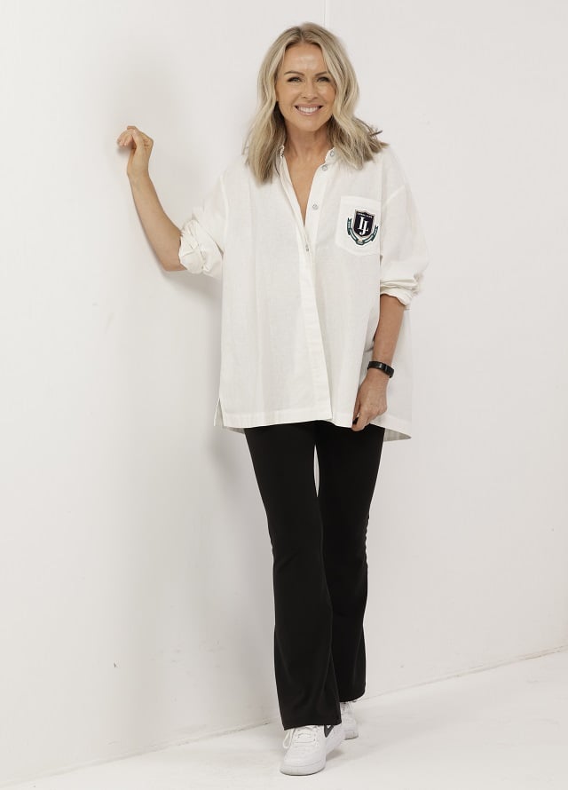 Lorna Jane wearing tight black flare leggings and white button up shirt
