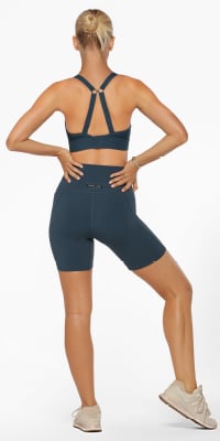 woman wearing blue bike shorts and adjustable sports bra