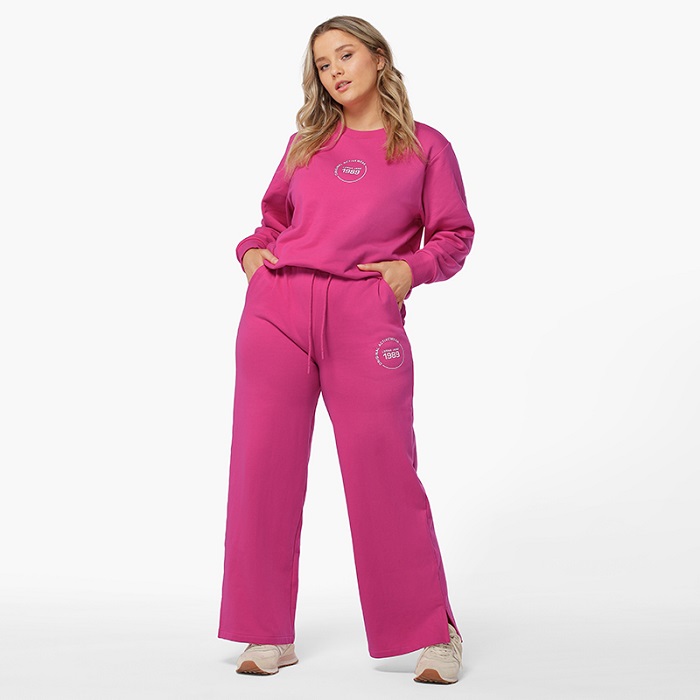woman wearing bright pink sweatpant joggers and matching sweater