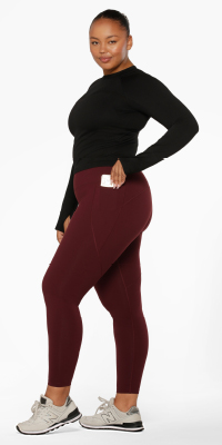 woman wearing a black long sleeve top and red leggings